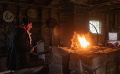 A Victorian-era Smithy overseeing the workshop's forge.